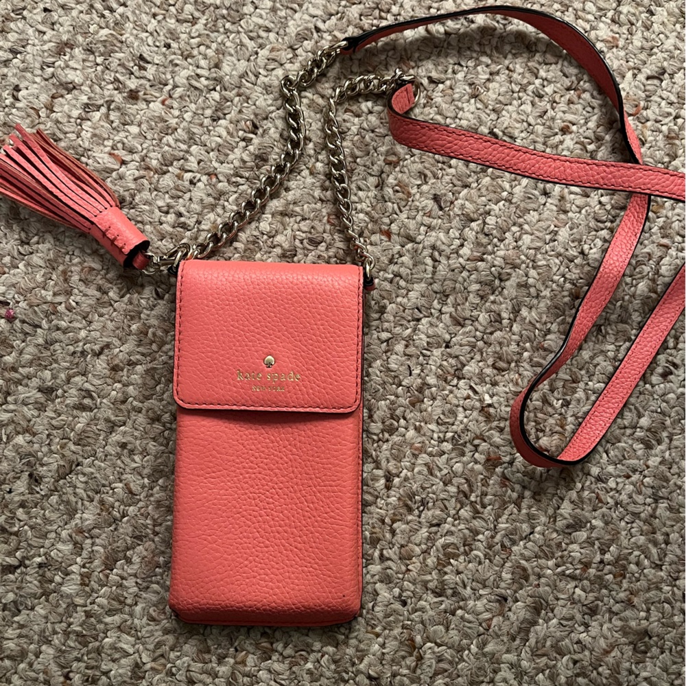 Salmon colored Kate Spade phone and card bag.